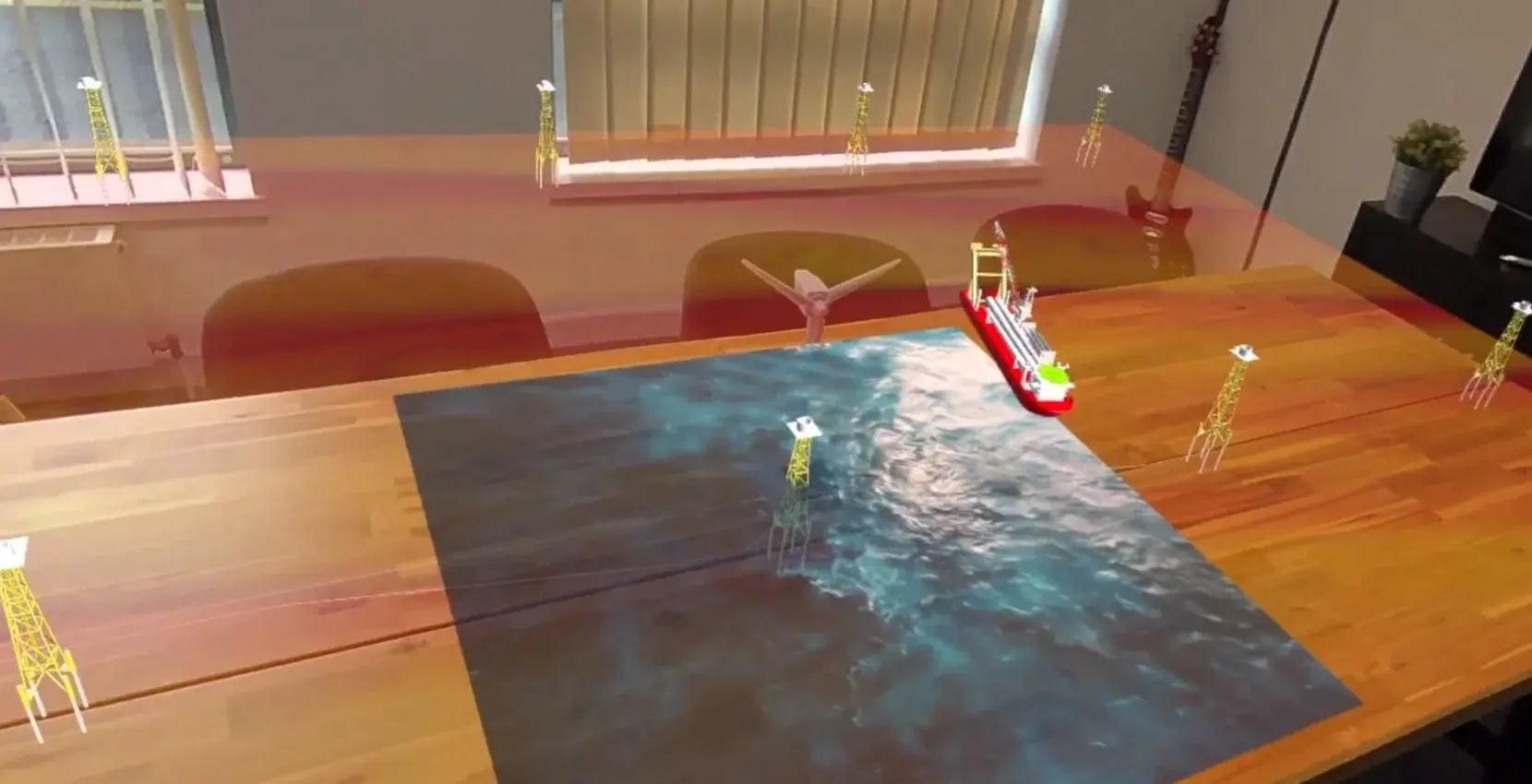ROC XR on Meta Quest 3 pass-through: a digital installation vessel approaches an empty jacket foundation on a sea surface laid over a meeting room table